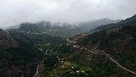 Valley with a road winding through clouds Stock Footage 230502164