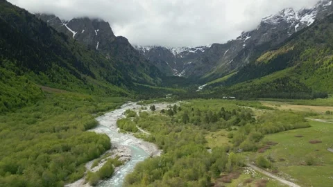 Valley with steep mountains, flight over a mountain river, aerial view Stock Footage 276966907