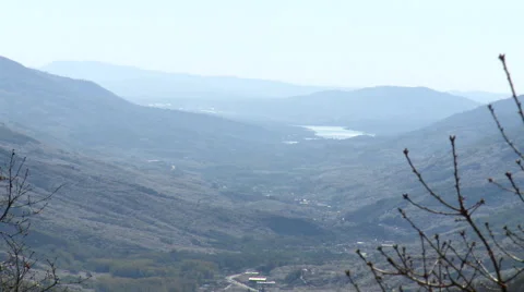 Valley from vantage point behind moving branches Stock Footage 49652634