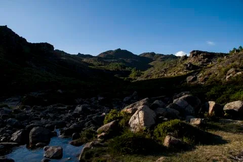 Valley with view to higher mountains Stock Photos