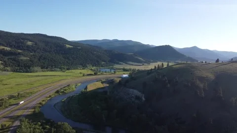 Valley View with River, Forest, and I-90 Traffic: Trucks and Cars Passing Stock Footage 246496147