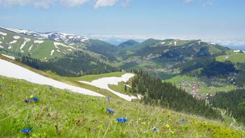 Valley villages and snow-capped mountains that have not completely melted Stock Footage 314632353