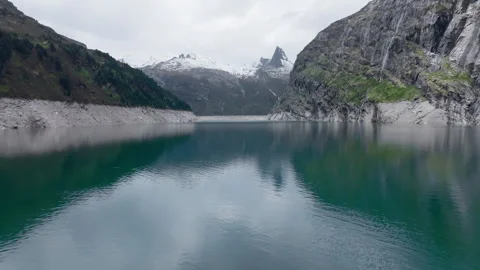 Vals - Cinematic view over its Alpine Dam Stock Footage 312700380