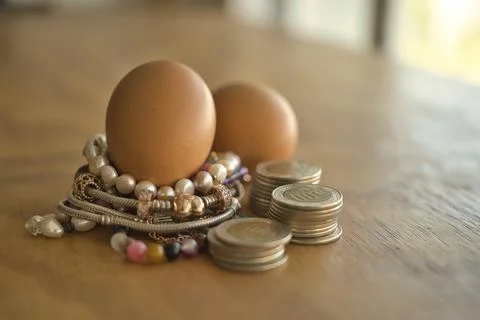 Valuable eggs with coins Foto stock