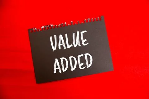 Value added message written on black paper with red background. Conceptual .. 写真素材