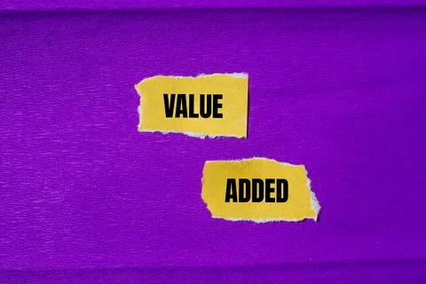 Value added message written on ripped torn yellow paper pieces with purple .. Stock Photos