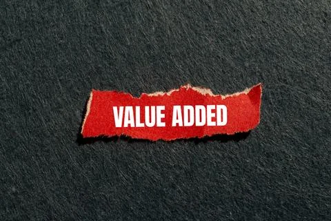 Value added message written on ripped torn red paper piece with gray backgr.. Stock Photos