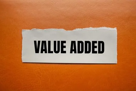 Value added message written on ripped torn paper piece with brown backgroun.. 写真素材