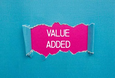 Value added message written on ripped torn blue paper with pink background... 스톡 사진