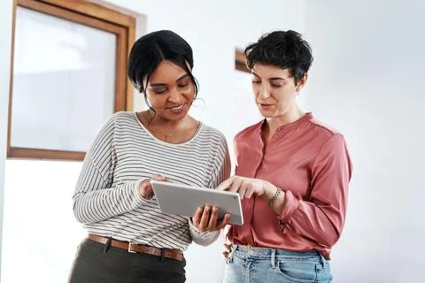 The value of an idea lies in using it. two attractive young businesswomen Stock Photos
