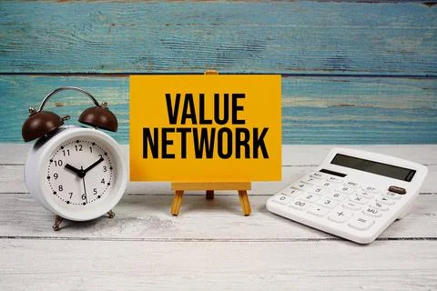 Value Network text written on paper card with calculator and alarm clock on.. Stock Photos