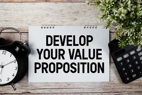 Value Proposition text with alarm clock and calculator on wooden background Stock Photos
