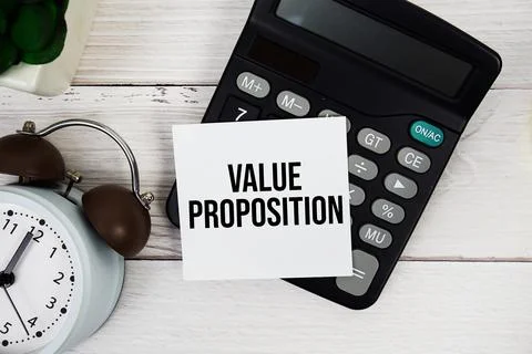 Value Proposition text on sticky note with alarm clock and calculator top v.. Stock Photos