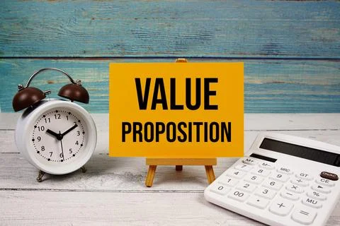 Value Proposition text written on paper card with calculator and alarm cloc.. Stock Photos
