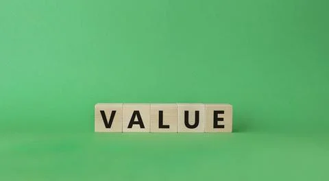 Value symbol. Concept word value on wooden cubes. Beautiful green backgroun.. Stock Photos