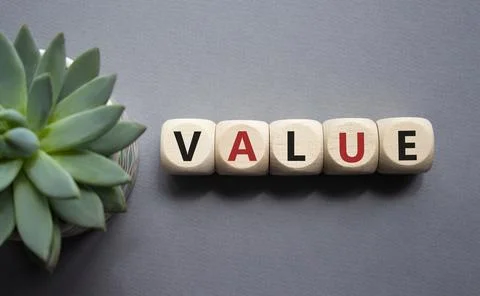 Value symbol. Concept word value on wooden cubes. Beautiful grey background.. Stock Photos