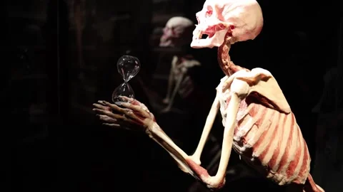 Value of time skeleton holding hourglass Stock Footage 330679804