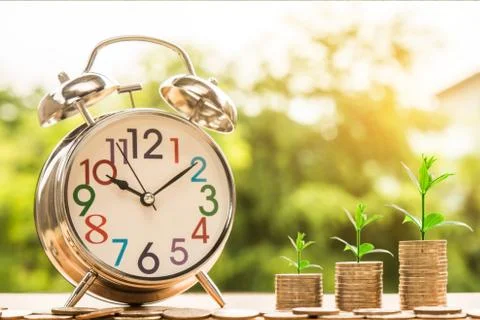 Value of time with small clock Stock Photos