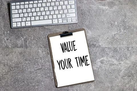 Value your time written on clipboard, desktop keyboard  Stock Photos