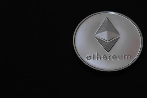 Valueable silver ether coin from cryptocurrency on black right Stock Photos