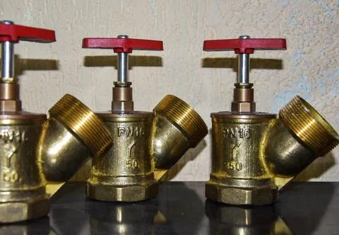 Valve 15 b3r - angle fire valve made of brass with a red lever. Valve for Stock Photos