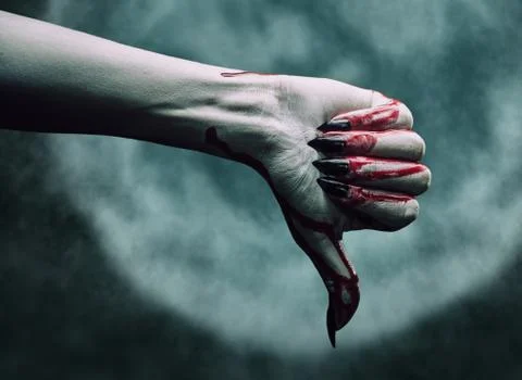 Vampire bloody hand shows thumb down gesture Stock Photos