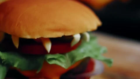 Vampire burger showing pointed vegetable teeth, 4K Stock Footage 341117610