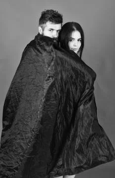 Vampire in cloak behind sexy devil girl. Man and woman dressed like vampire Foto stock
