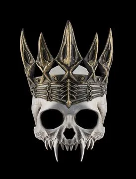 Vampire skull with long sharp fangs and ancient golden crown on black background Stock Photos