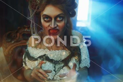 Vampires. Bloodthirsty female vampire in the old abandoned castle. Vintage st Stock Photos