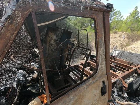 Van completely destroyed by fire and abandoned. Stock Photos