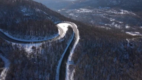 Van drive in snow winter day on the road mountain range aerial view Stock Footage 261171943