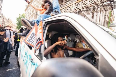 Van Driver smoking cigarette while Huge crowd of Black Lives Matters Stock Photos