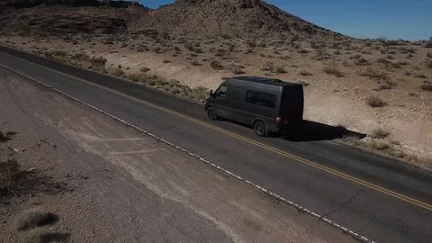 Van Drives Away Down Desert Road Aerial Shot Vídeos de archivo 99096928
