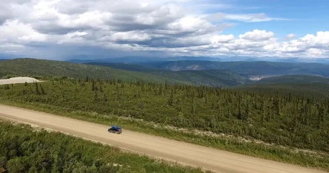 Van drives on an unpaved road in the wilderness Stock Footage 86153300