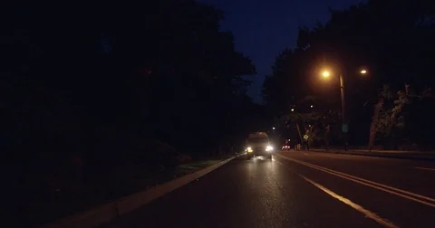 Van driving on a dark street at night Stock Footage