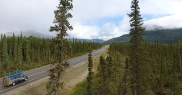Van driving through Forest road trip establisher  Stock Footage 86149923