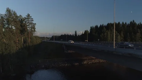 A Van Driving towards Sunset on a Bridge and Strait Video stock 85976939