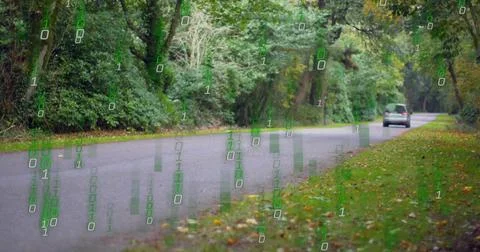On van entering frame, minivan moving right, receding while binary digits rising Stock Photos