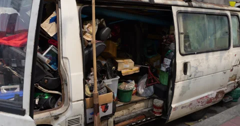 Van full of old trrash and junk parked at street, move closer to open door Видео 326376418