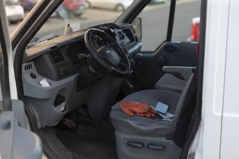 Van interior with gloves and keys. Work gloves and steering wheel inside van Stock Photos