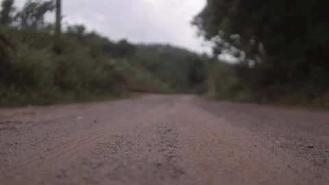 VAN LEAVING RURAL AREA CAMERA CLOSE TO THE GROUND Stock Footage 148188813