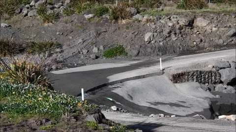 Van negotiates a ford on Cape Palliser road, N.Z. Stock Footage 56225193