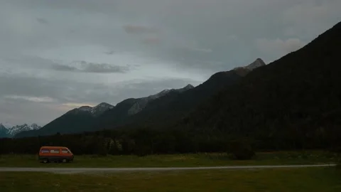 Van parked by large mountain at dusk Stock Footage 140611979
