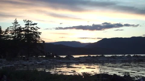 Van Parked at Seaside with Sunset on Island with Mountains in the Background Stock Footage 233470532