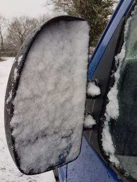 Van side mirror covered in sleet and snow Stock Photos