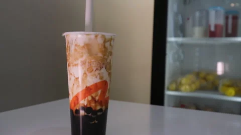 Vancouver Canada 05.05.2024 preparation of Bubble Tea drink made from brown Stock Footage 274470581