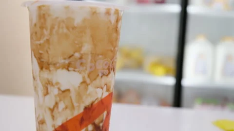 Vancouver Canada 05.05.2024 preparation of Bubble Tea drink made from brown Stock Footage 274470633