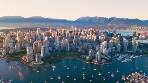 Vancouver downtown skyline aerial pullback reveal shot, BC, Canada at sunset Stock Footage 237513163