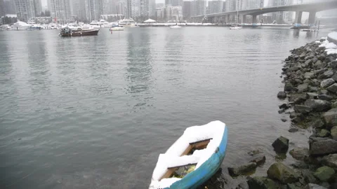 Vancouver harbour, camera tilts from abandoned dingy to skyline of buildings, Stock Footage 168336044